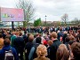 Spectators watch the Oxford and Cambridge University Boat Race on a big screen