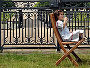 A young girl relaxes in the sunshine at the Hampton Court Palace Flower Show
