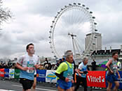 Running along the Embankment past the London Eye on the South Bank at the London Marathon