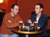 Men enjoy a pint in a London bar