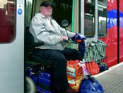 Wheelchair user on the Docklands Light Railway. Copyright Britain on View