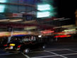 London taxi driving through Piccadilly Circus at night