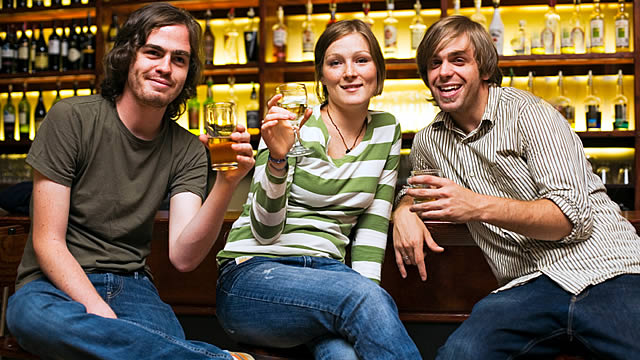 Three friends at a bar