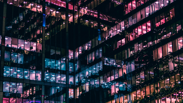 An office block at night with various lights still turned on