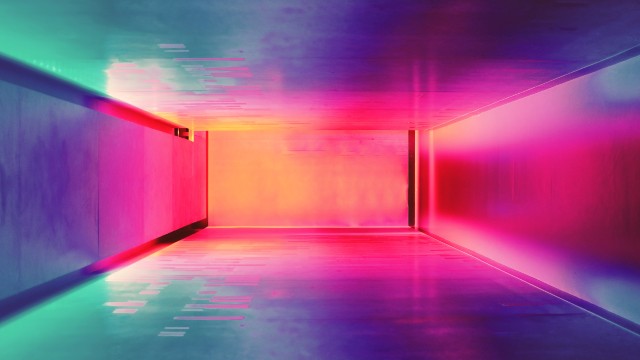 Corridor lit in bright pink, purple and green colours.