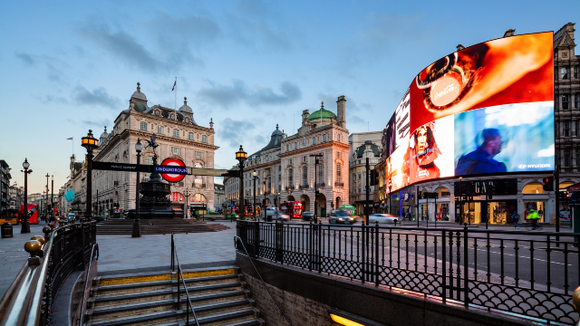 The bright lights of Piccadilly Circus as seen from the steps of the Piccadilly tube station.