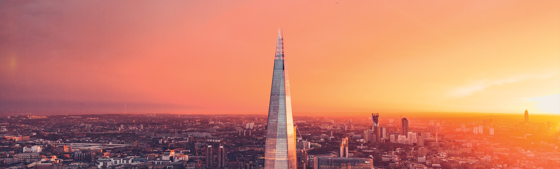 A panoramic view of London during a sunset with the Shard at the centre