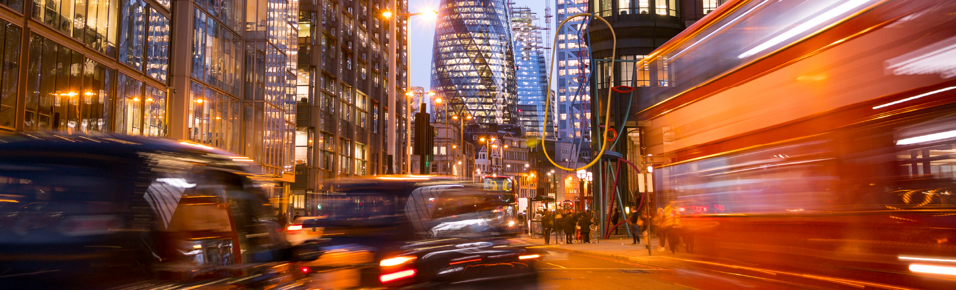 Night shot of a street in the City of London with a motion blur effect on the cars