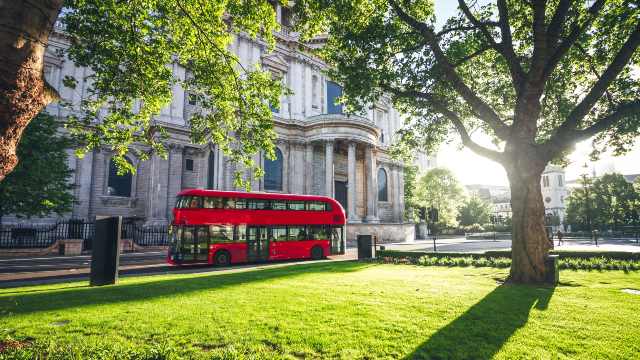 Bus passing by St Paul's Cathedral on a sunny day.