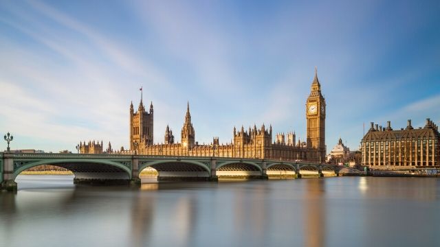 Big Ben, Houses of Parliament and Westminster Bridge in golden sunlight in Westminster.
