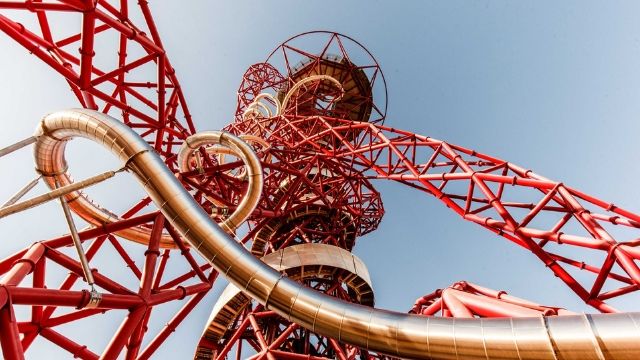 ArcelorMittal Orbit, a long tunnel slide within a red metal construct, looking up to the top of the slide.