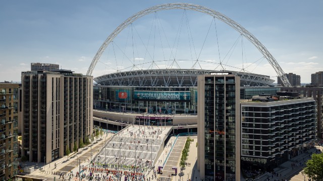 Exterior view of Wembley Stadium and crowds arriving to watch a game during the UEFA EURO 2020 tournament.