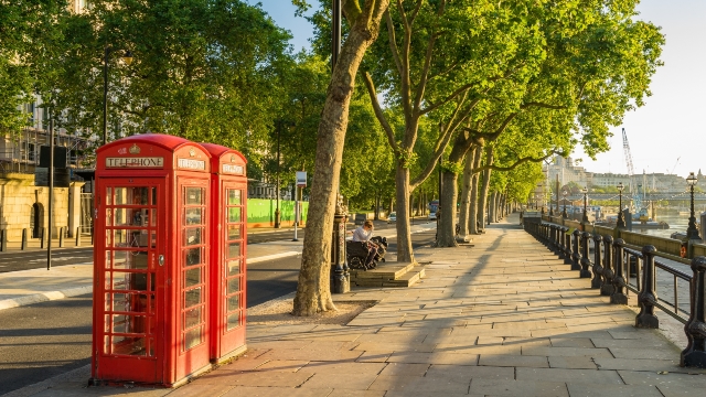 Traditional red phone boxes alongside the river Thames