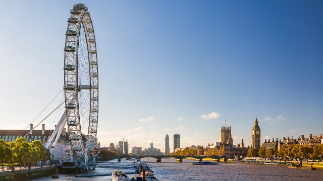 The river Thames on a sunny day, with Westminster in the background.