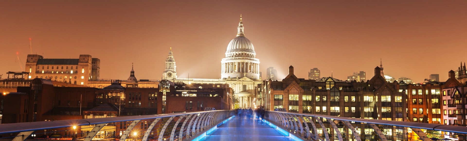 View of St Paul's cathedral from Millennium Bridge at night.