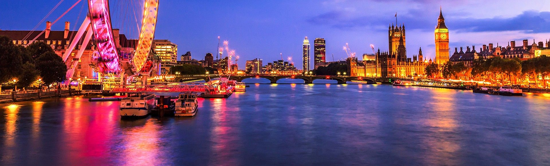 A view across the Thames at night, including the London Eye