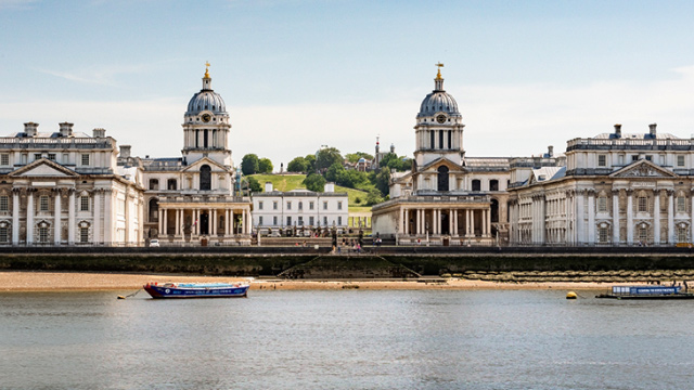 View of the Old Royal Naval College building from the river Thames in Greenwich, London.