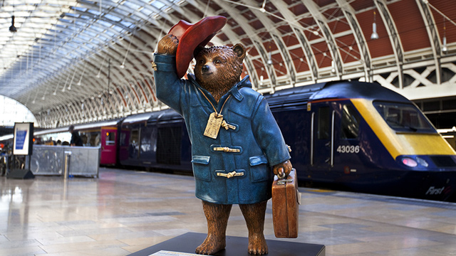 Statue of Paddington Bear on the train platform at Paddington Station in London.