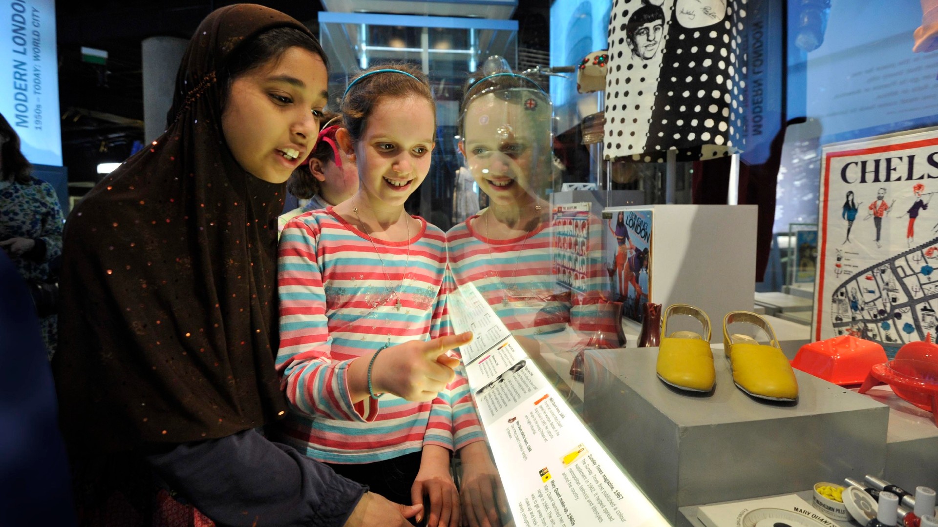 Children look at cases in World City at the Museum of London. Image courtesy of the Museum of London.