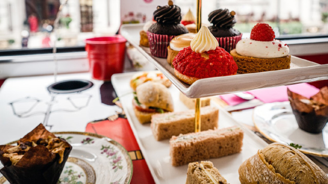 Treat the kids to a tasty afternoon tea © Sebastian Coman Photography via Unsplash. Image courtesy of Sebastian Coman Photography via Unsplash. A selection of colourful cakes and sandwiches on serving plates