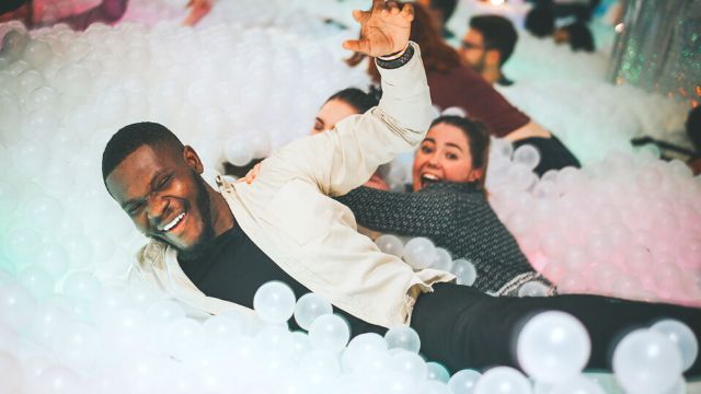 People have fun playing in the adult ballpit at the ballieballerson brunch in London.