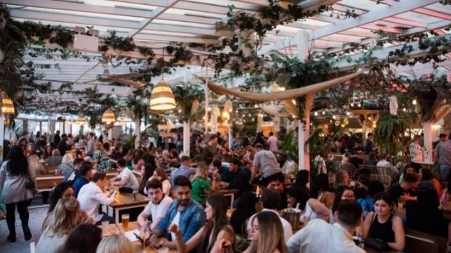 People enjoy mexican food and drinks on the rooftop terrace at pergola paraiso paddington. 