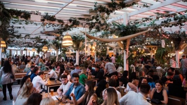 People enjoy mexican food and drinks on the rooftop terrace at pergola paraiso paddington.