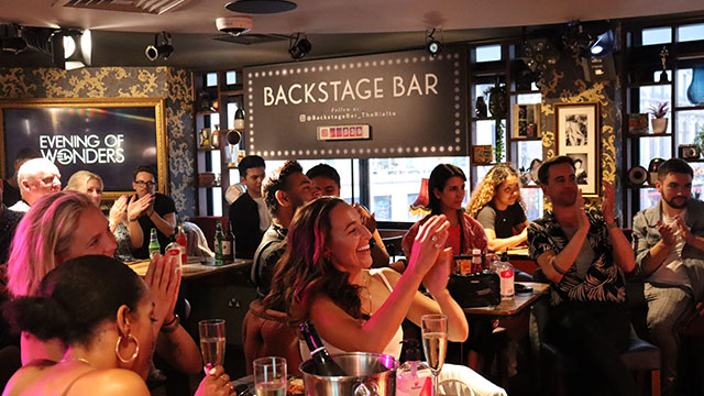An audience applauding a show at The Rialto Backstage Bar
