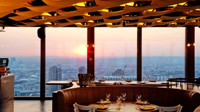 A panoramic shot of a restaurant over looking the City skyline