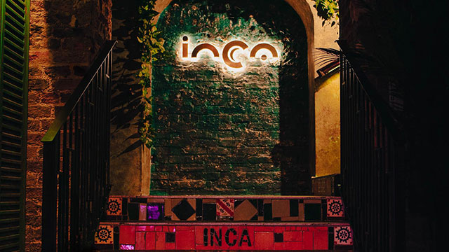 Steps leading up to a leafy arch at Inca restaurant in London