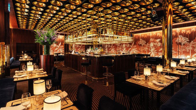 The elegant red and gold interior of Isabel restaurant in Mayfair 