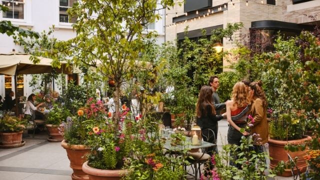 Guests enjoy the outdoor dining space at La Goccia restaurant in Covent garden, surrounded by flowers and plants. Image courtesy of Petersham Nurseries. Photo credits: Andrew Montgomery.