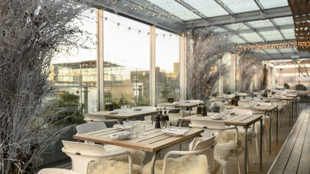 White tables with festive decor line the winter rooftop of boundary shoreditch.