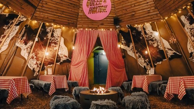 A cosy rooftop bar with furry seats and fairy lights at the queen of hoxton.