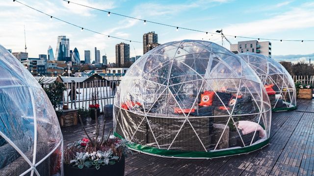 Glass igloos sit on the rooftop of Skylight Bar Tobacco Dock in London.