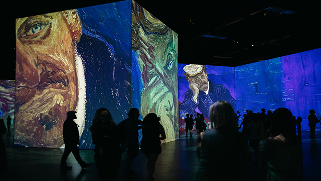 Van Gogh's paintings are projected against the walls, with visitors experiencing the vision of the artist.
