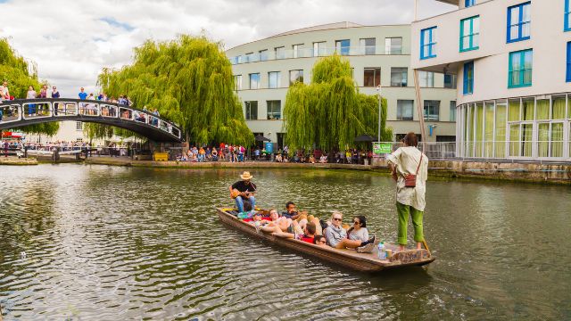 People enjoy a boat ride down Regents Canal near Camden Lock in London.