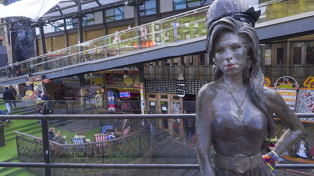 A statue of Amy Winehouse in front of the market place in Camden market.