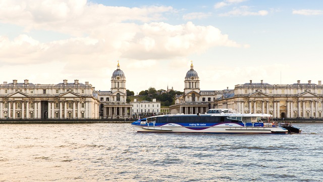 Float past landmarks with Thames Clippers. Image courtesy of Visit Greenwich. A Thames Clippers boat sails past the Old Royal Naval College in Greenwich.