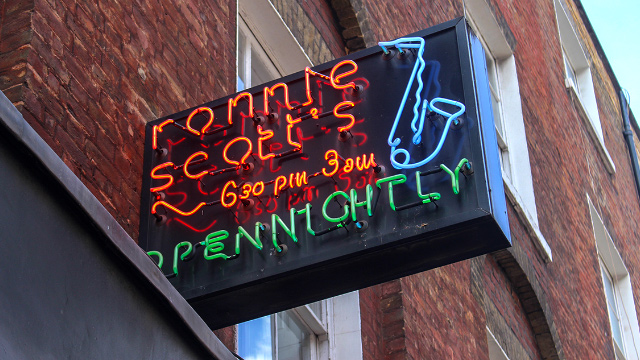 Red, green and blue neon sign of Ronnie Scott's jazz club in Soho, London.