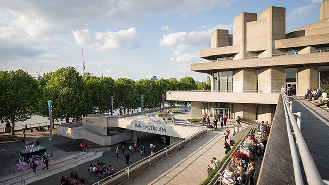 A view from the balcony of the Southbank Centre, with the brutalist-style National Theatre on the right and the riverside walkway on the left.