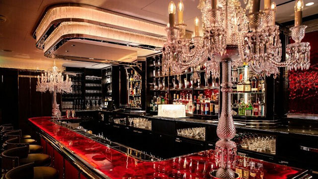 Sparkling chandeliers illuminate the world-class bar, decorated in rouge glows, plush velvet and leather banquettes.