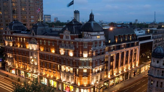 The exterior of Harvey Nichols department store lit up in the evening