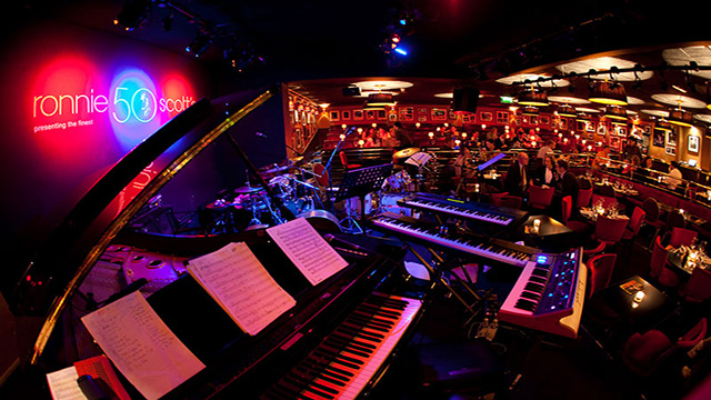 People listen and dance to jazz music at the famous Ronnie Scott's Jazz Club in London. 