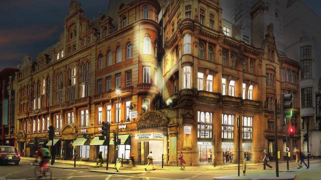 A night view over the Picturehouse Central cinema in central London, lighting up the street in the night.