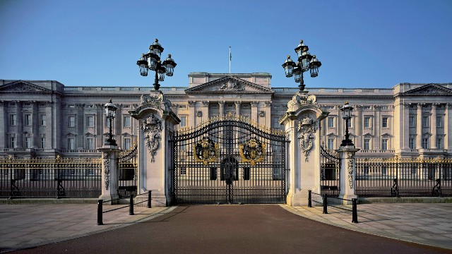 A view of the front of Buckingham Palace taken through the closed front gates.