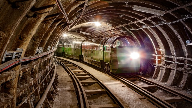 The Mail Rail train is travelling through a tunnel heading towards the photographer.