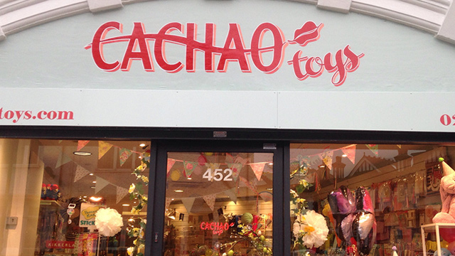 The shop front of Cachao toy shop showing the shop sign and a view through the windows.