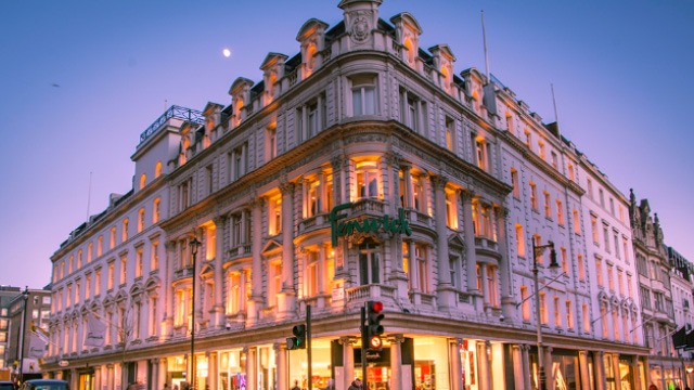 Exterior view of the architecture of Fenwick department store in London at dusk