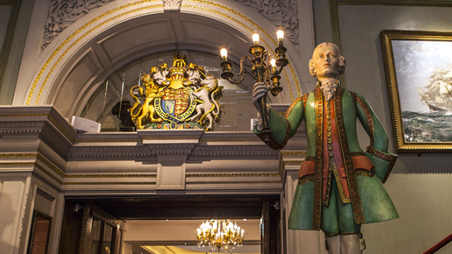 Statue holding a candelabra inside Fortnum & Mason in London